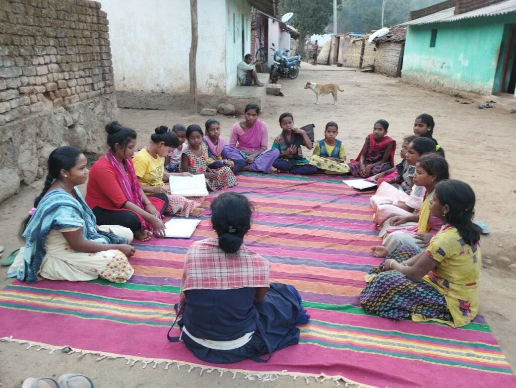 Girls of the TULSI program sitting in a circle during one of their regular meetings