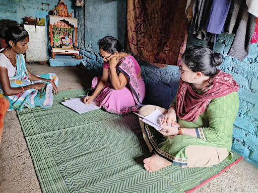 Aanganwadi workers, 2 of them, with a page and pen during a tool training program