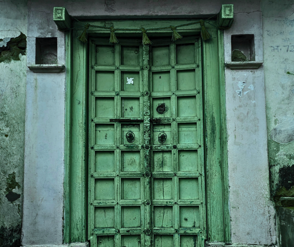 A traditional wooden green colored door