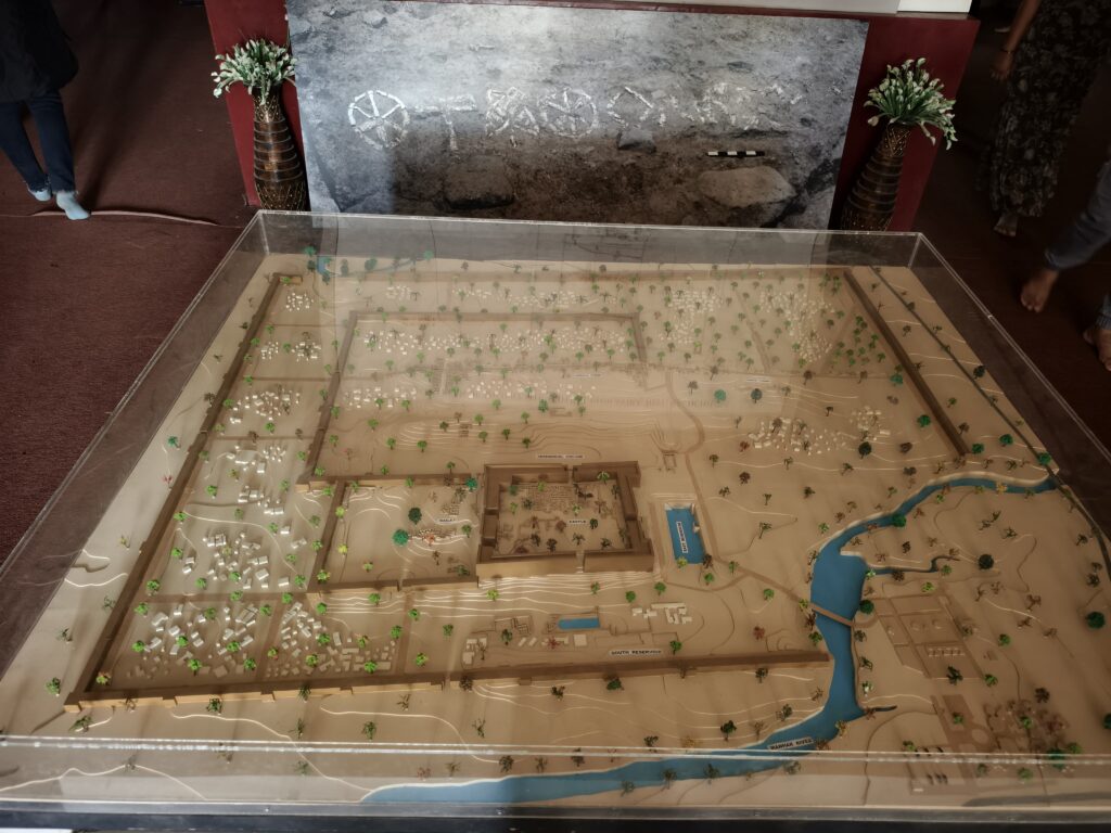 An ancient settlement model with houses, trees, and roads.